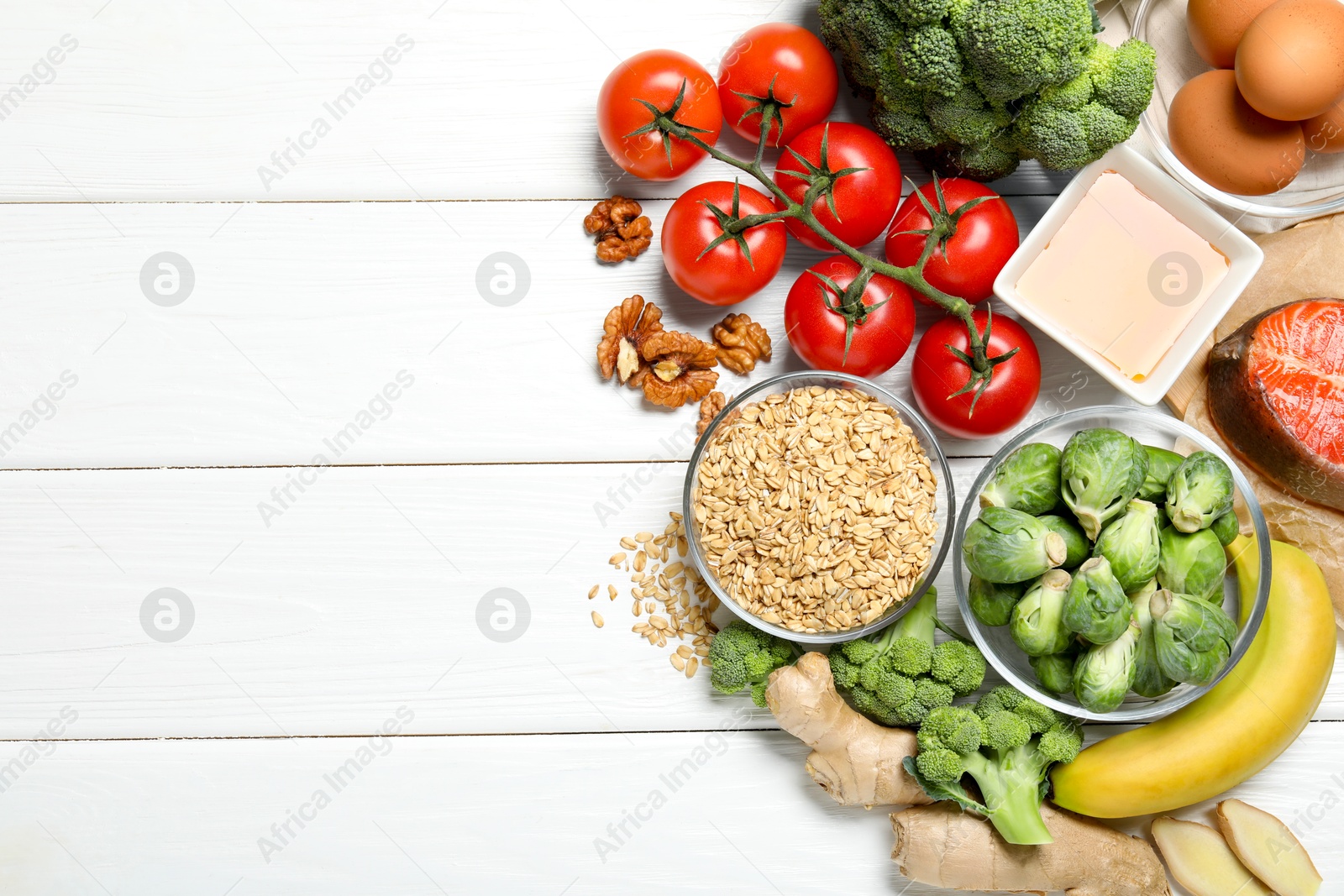 Photo of Different fresh products rich in melatonin on white wooden table, flat lay. Space for text