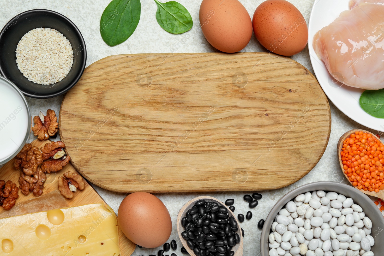 Photo of Wooden board with word Estrogen and different fresh products on light textured table, flat lay