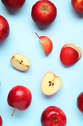 Photo of Fresh ripe red apples on light blue background, flat lay