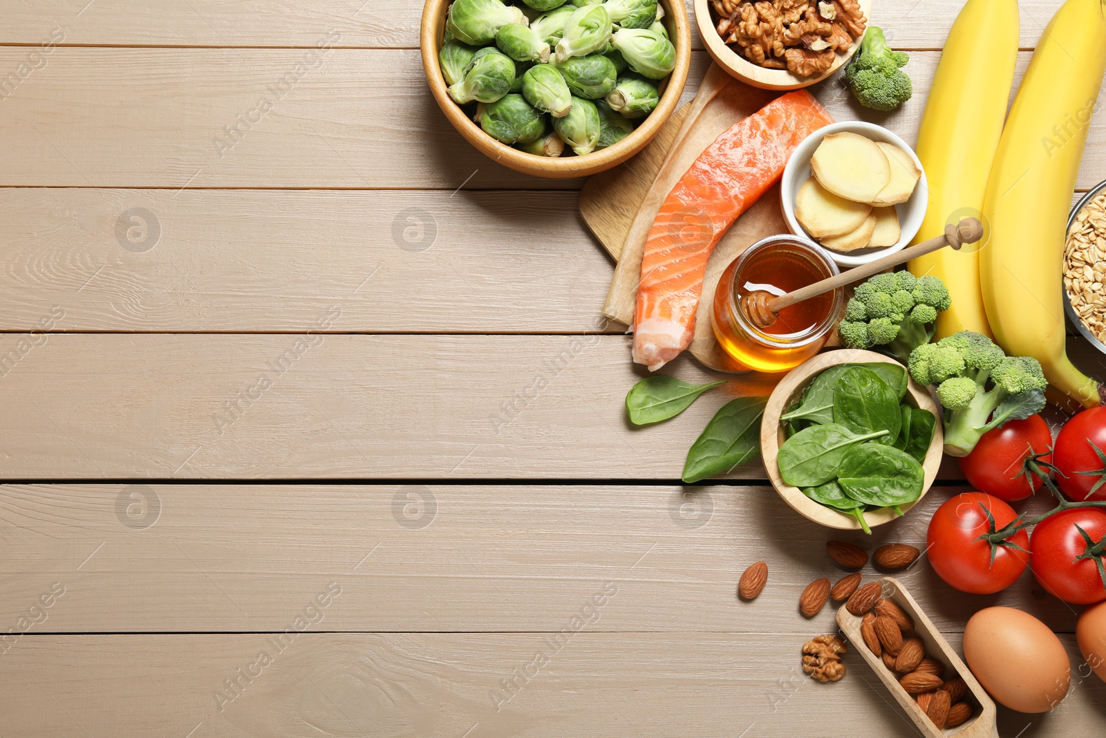 Photo of Different products rich in melatonin on wooden table, flat lay. Space for text