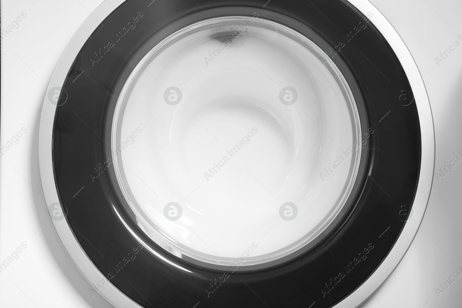 Photo of Washing machine with suds as background, closeup