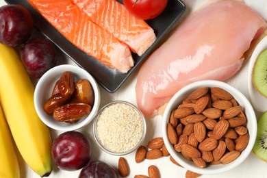 Photo of Different products rich in serotonin on white wooden table, flat lay