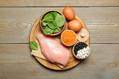 Photo of Different products rich in estrogen on wooden table, top view