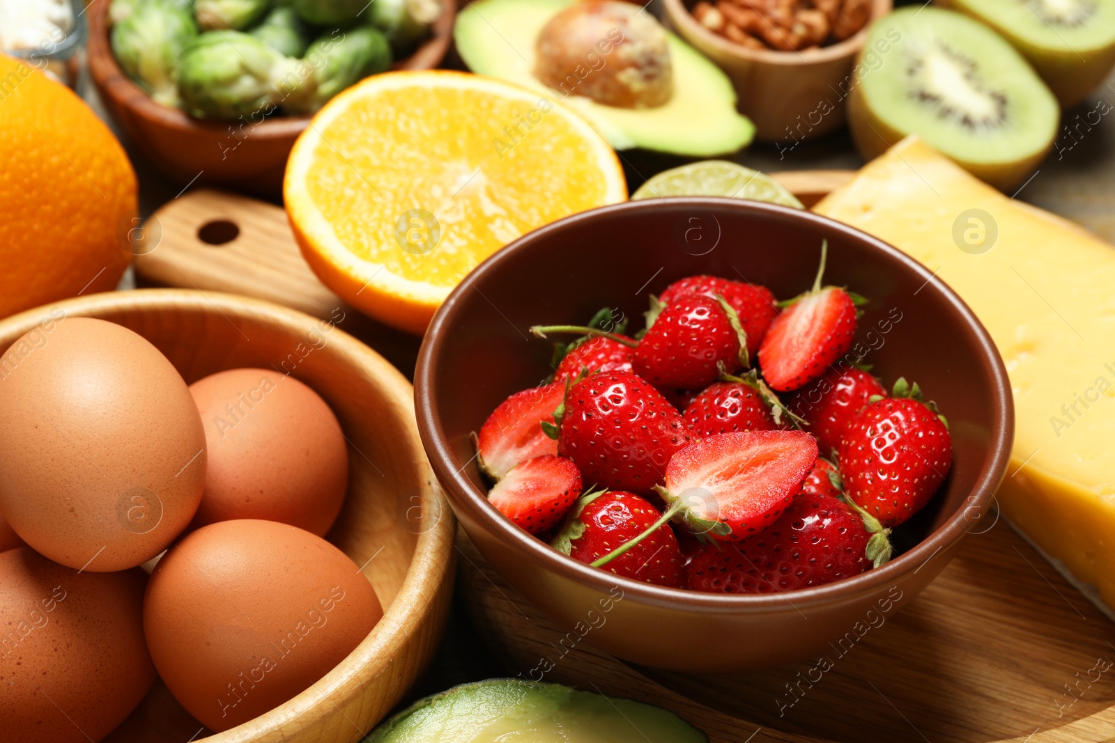 Photo of Different products rich in dopamine on wooden table, closeup