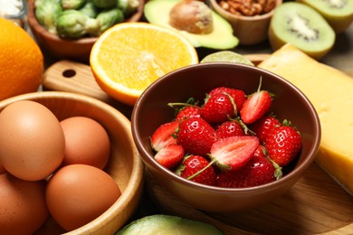 Photo of Different products rich in dopamine on wooden table, closeup