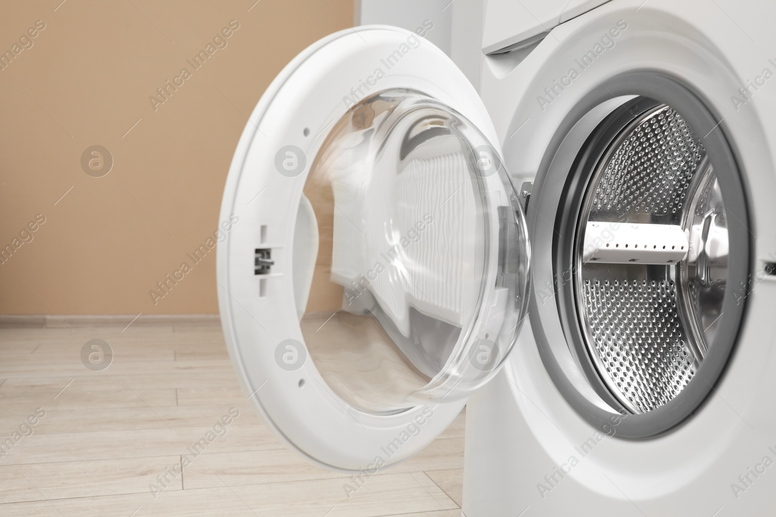 Photo of Washing machine with empty drum indoors, closeup