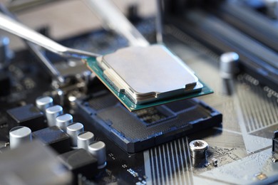 Photo of Installing modern computer chip onto motherboard, closeup