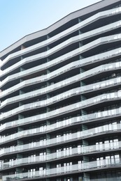 Modern building with many windows outdoors, low angle view