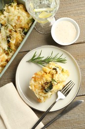 Photo of Tasty pasta casserole with cheese and broccoli served on wooden table, flat lay