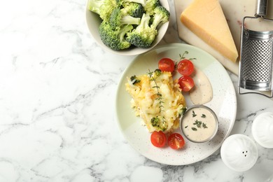 Photo of Tasty pasta casserole with cheese and broccoli served on white marble table, flat lay. Space for text