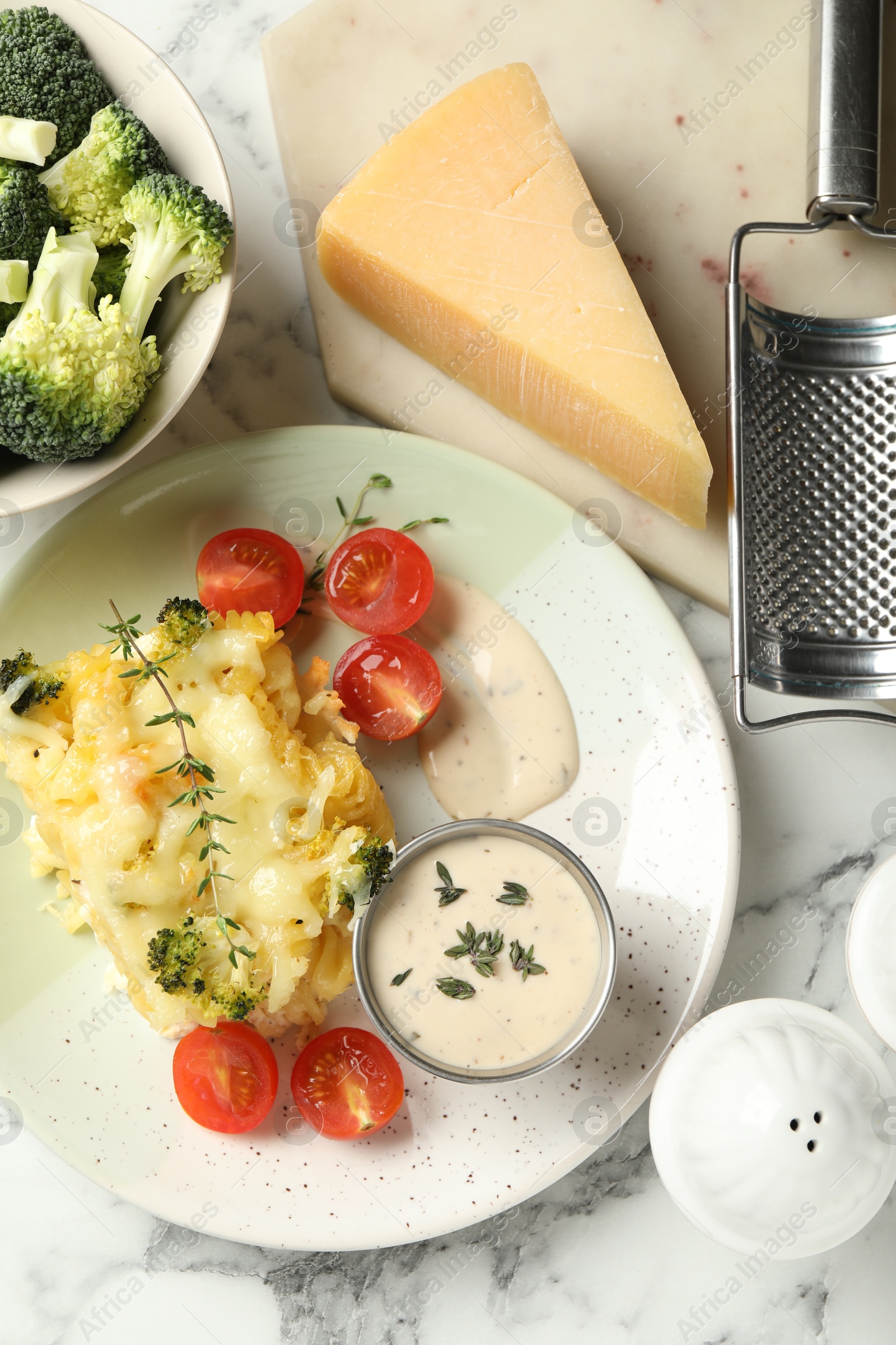 Photo of Tasty pasta casserole with cheese and broccoli served on white marble table, flat lay