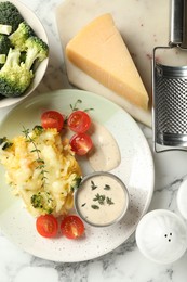 Photo of Tasty pasta casserole with cheese and broccoli served on white marble table, flat lay