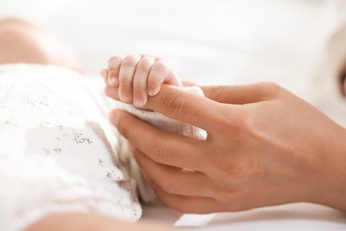 Photo of Mother with her cute little baby at home, closeup