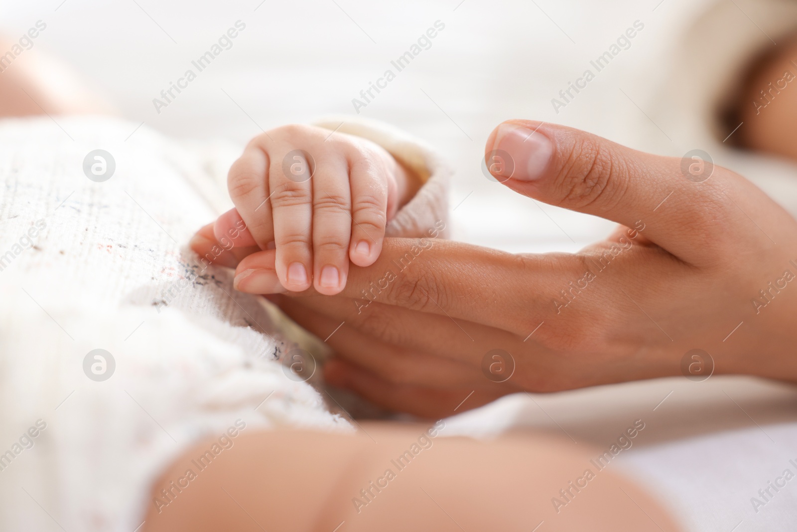 Photo of Mother with her cute little baby at home, closeup