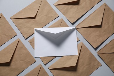 Photo of Paper envelopes on gray background, flat lay. Mockup for design