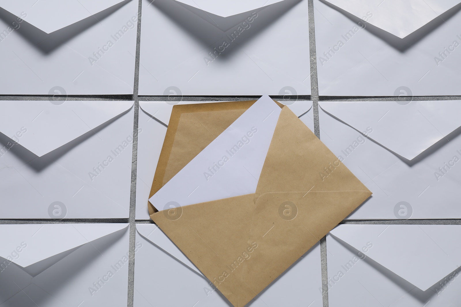 Photo of Paper envelopes with letter on gray background, top view. Mockup for design