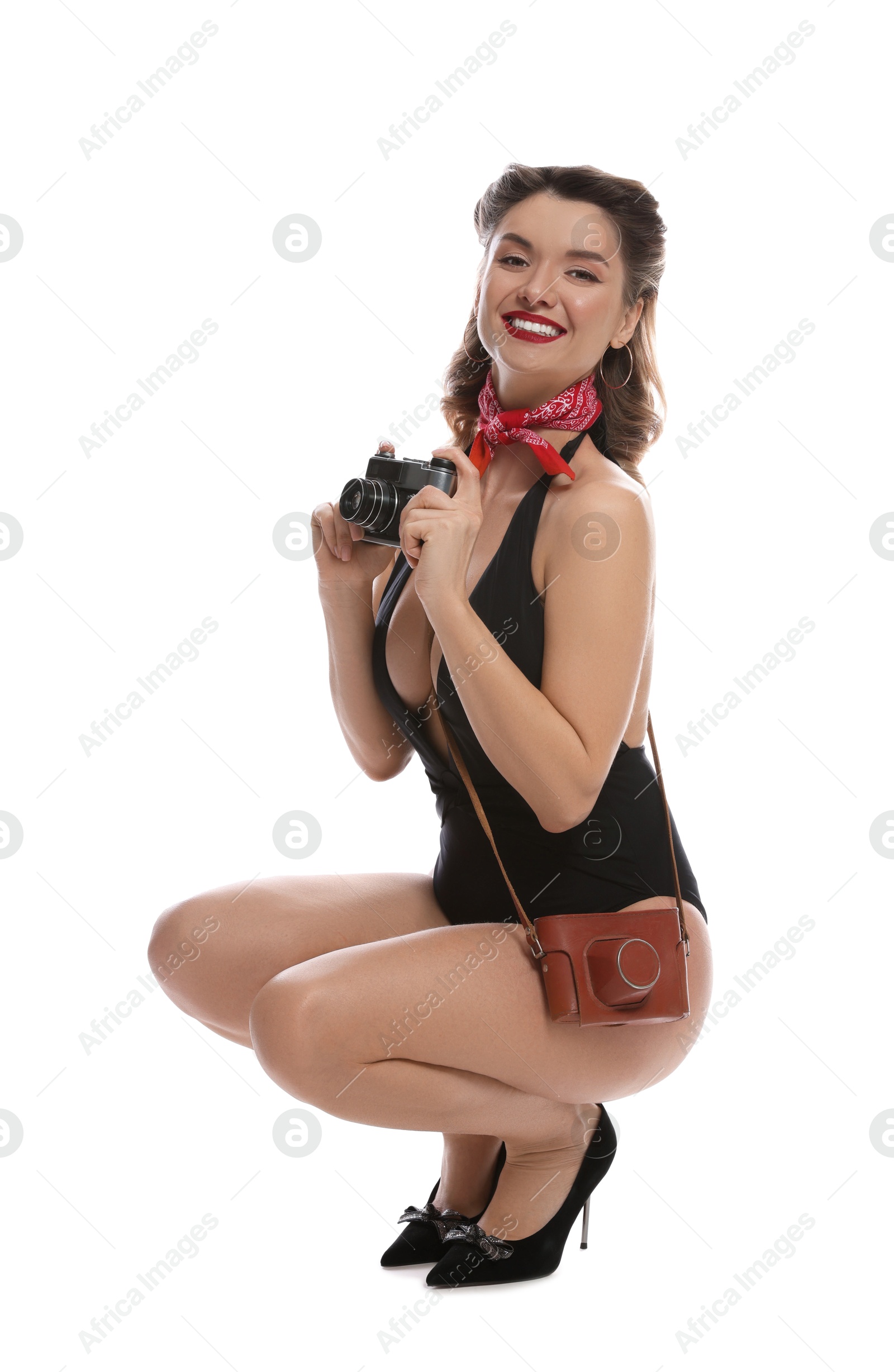 Photo of Happy pin-up woman in swimsuit with vintage camera on white background