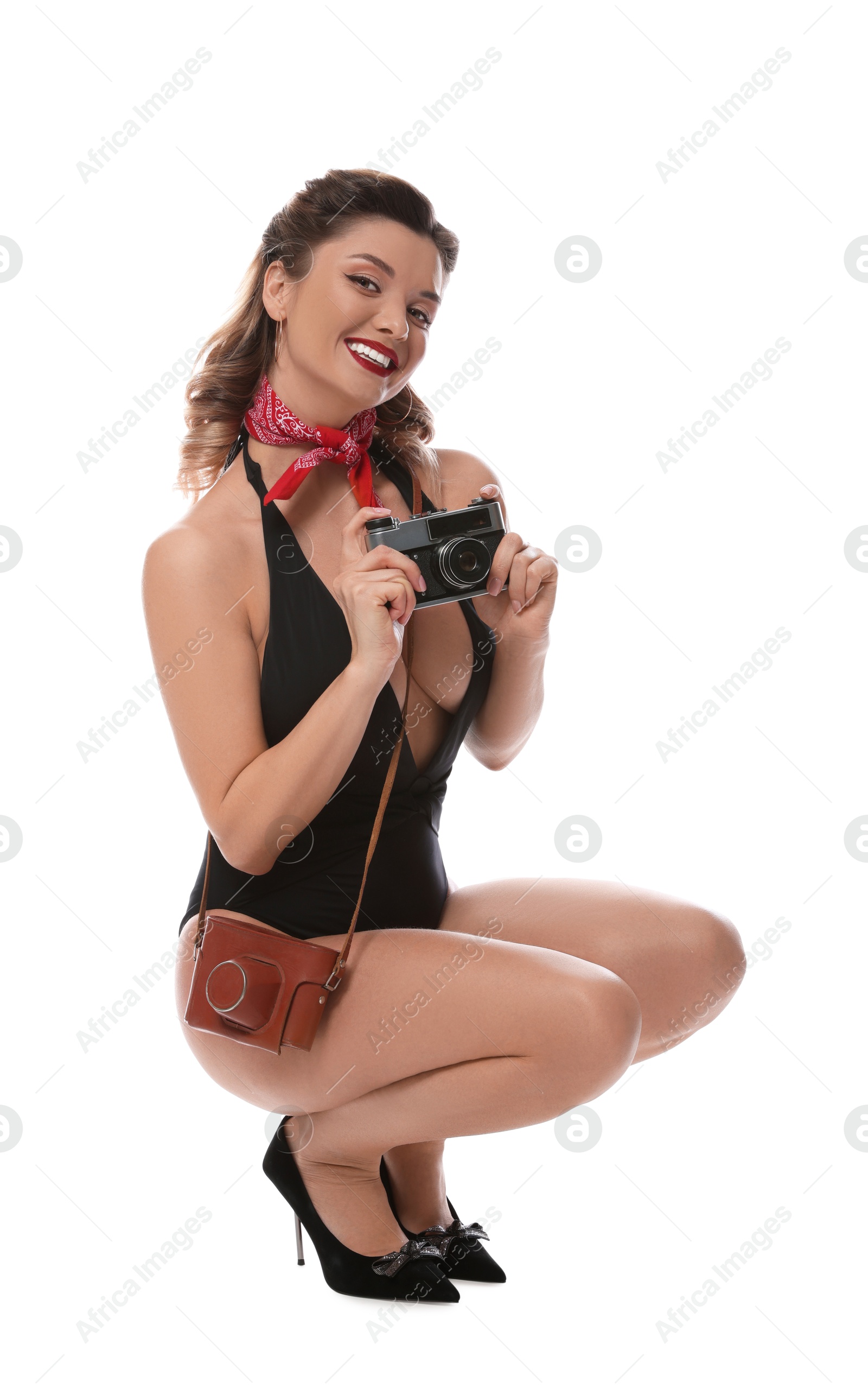 Photo of Happy pin-up woman in swimsuit with vintage camera on white background