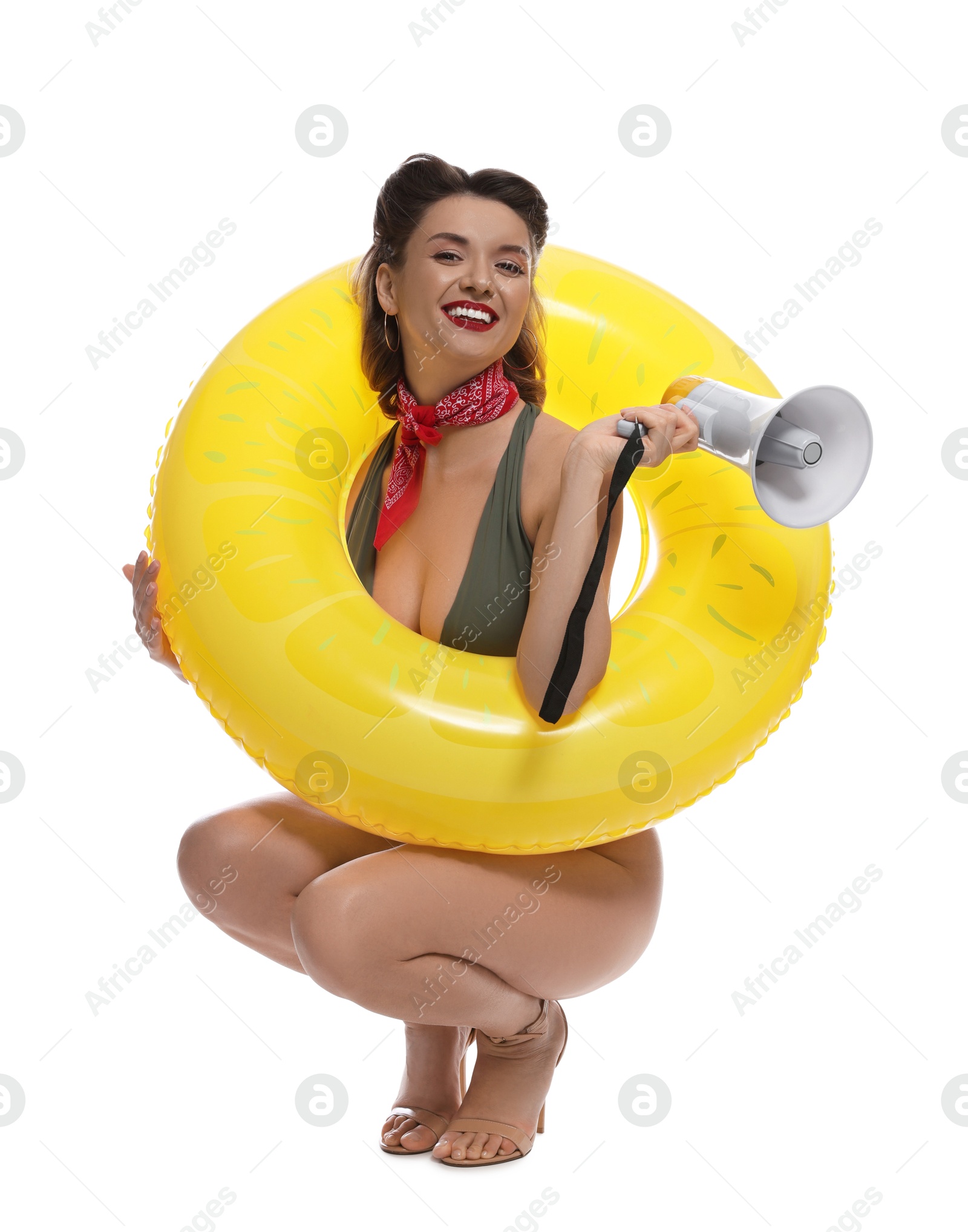 Photo of Happy pin-up woman in swimsuit with megaphone and inflatable ring on white background