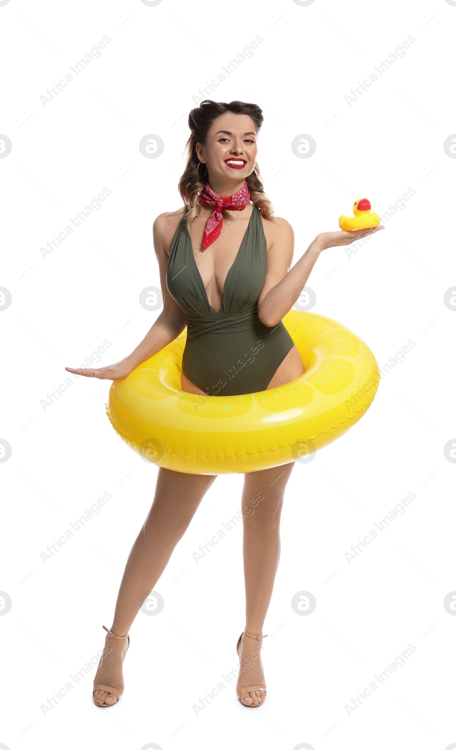 Photo of Happy pin-up woman in swimsuit with rubber duck and inflatable ring on white background