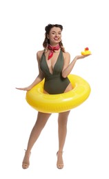 Photo of Happy pin-up woman in swimsuit with rubber duck and inflatable ring on white background