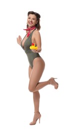 Photo of Happy pin-up woman in swimsuit with rubber duck on white background