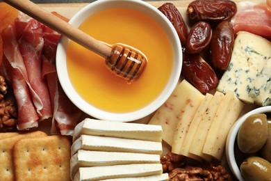 Photo of Different types of delicious cheese and other snacks as background, top view