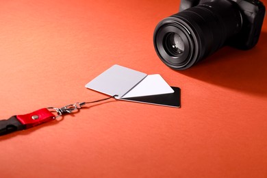 White balance calibration cards and camera on red background