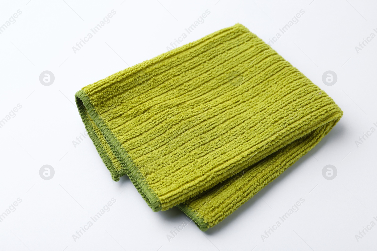 Photo of Clean green microfiber cloth on white background, closeup