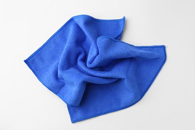 Photo of Clean blue microfiber cloth on white background, top view