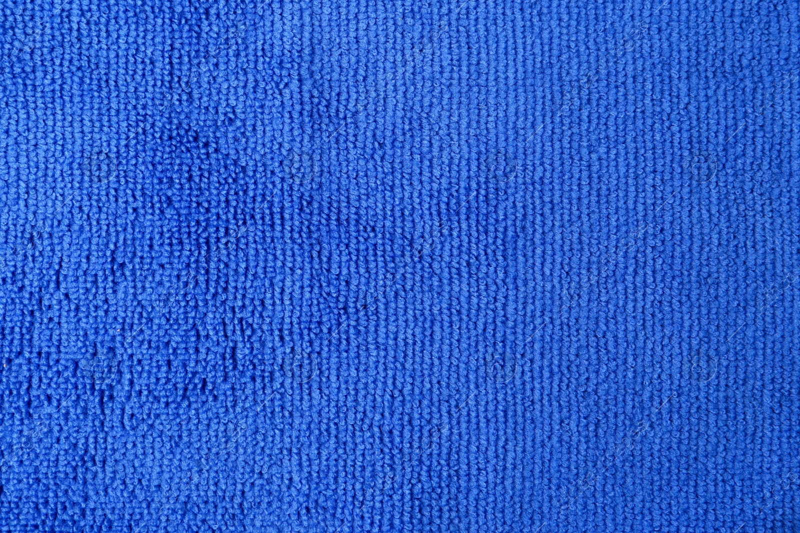 Photo of Clean blue microfiber cloth as background, top view