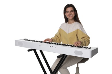 Photo of Smiling woman playing synthesizer on white background