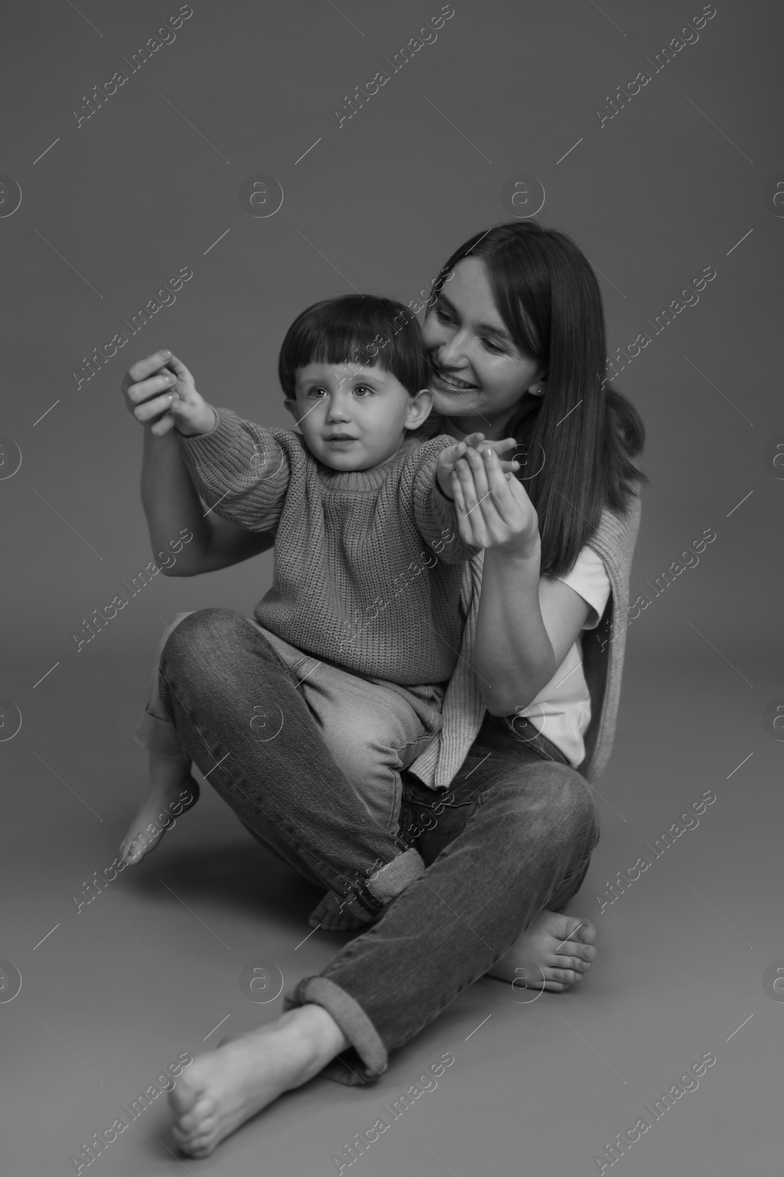 Photo of Happy mother with her little son, black and white effect