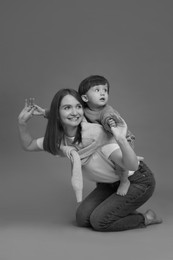 Photo of Happy mother with her little son, black and white effect