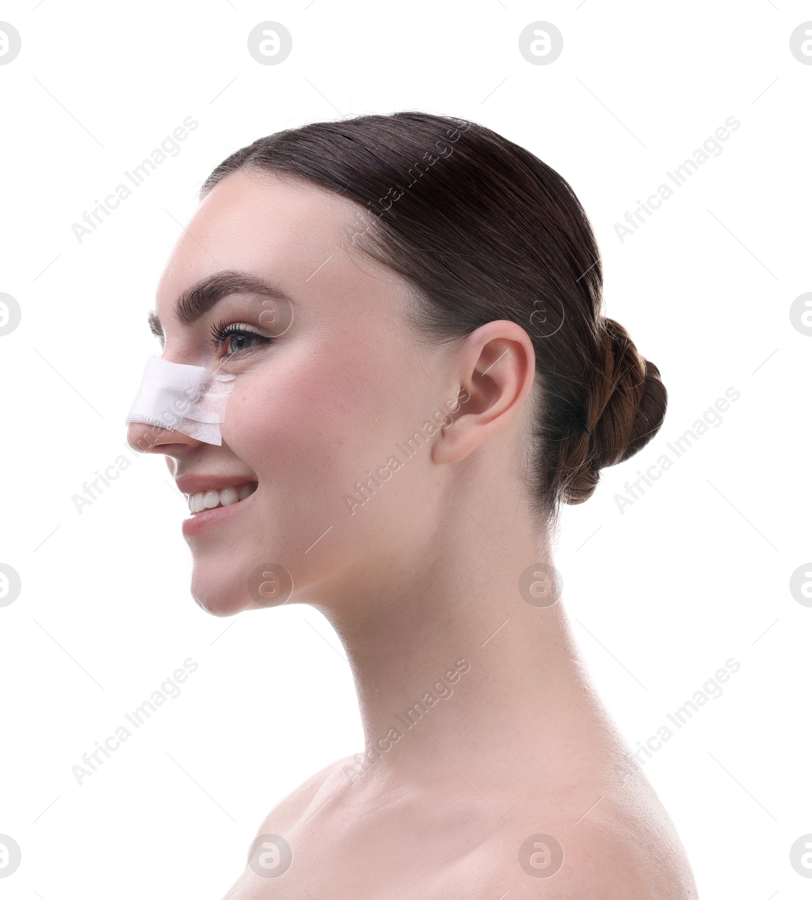 Photo of Woman with medical bandage on her nose after plastic surgery operation against white background