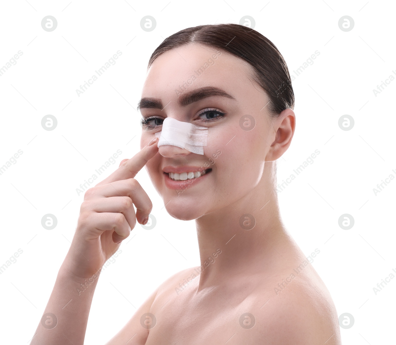 Photo of Woman with medical bandage on her nose after plastic surgery operation against white background