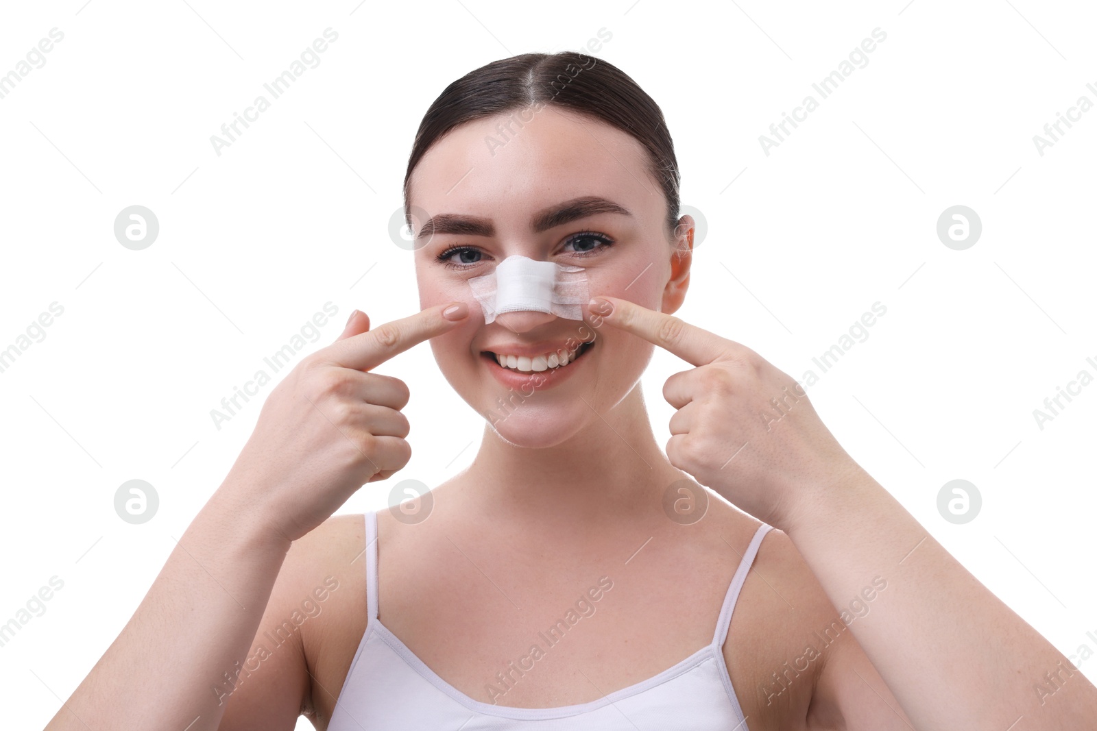 Photo of Woman with medical bandage on her nose after plastic surgery operation against white background