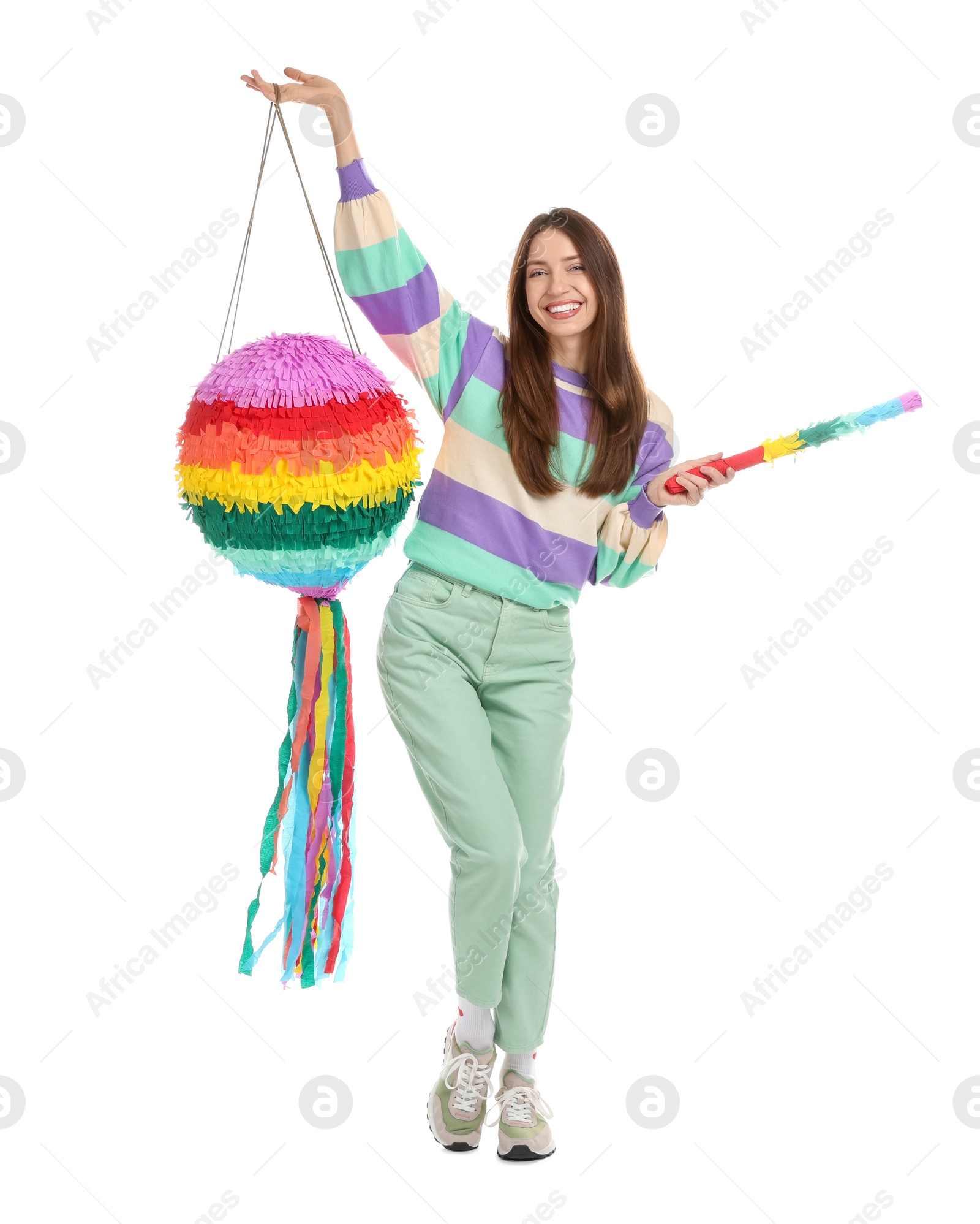 Photo of Happy woman with colorful pinata and stick isolated on white