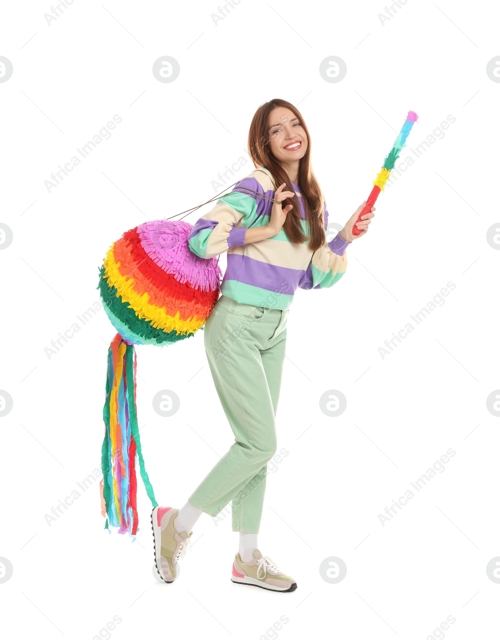 Photo of Happy woman with colorful pinata and stick isolated on white