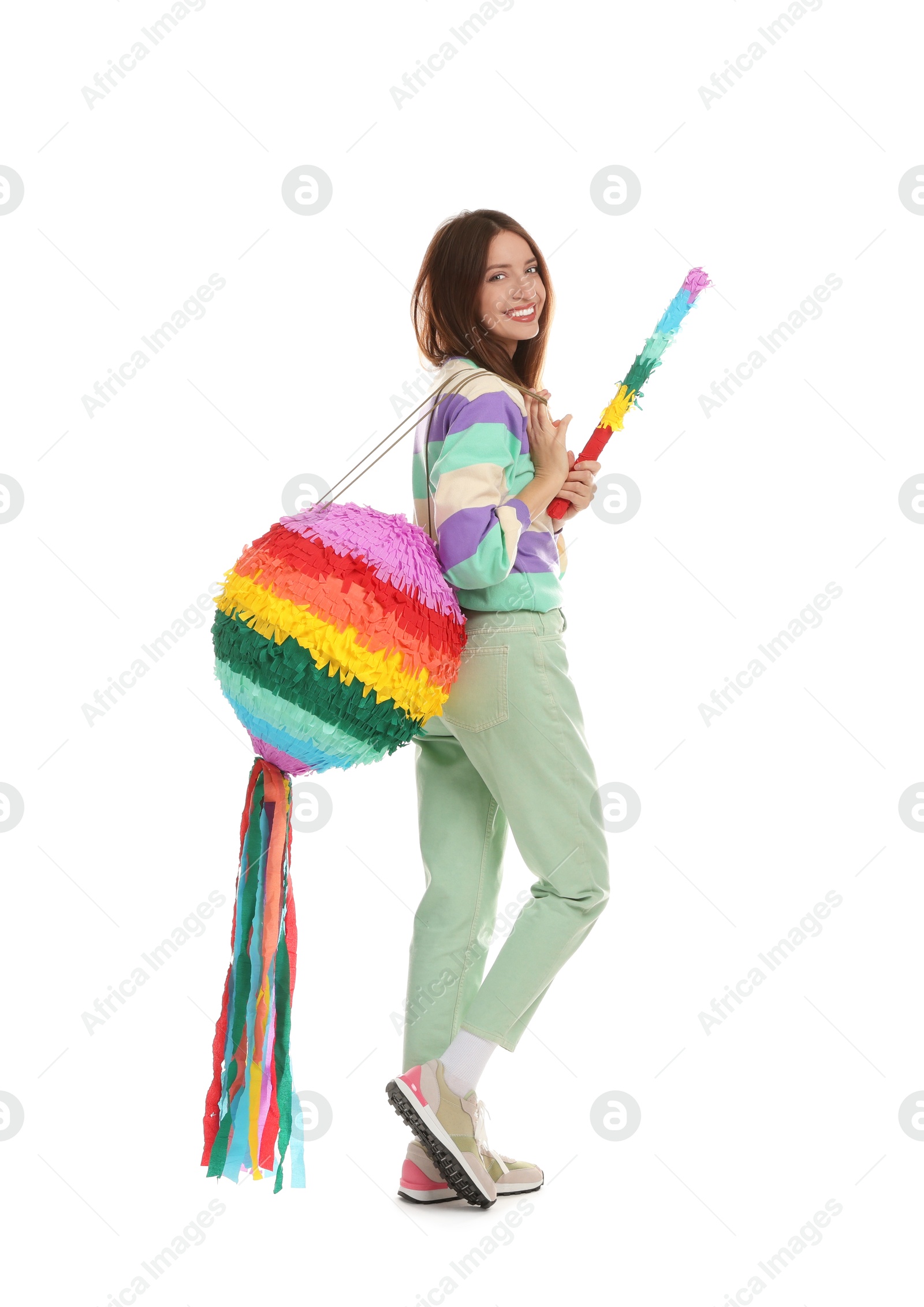 Photo of Happy woman with colorful pinata and stick isolated on white