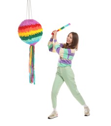 Photo of Happy woman breaking colorful pinata with stick on white background