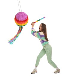 Photo of Emotional woman breaking colorful pinata with stick on white background