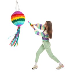 Photo of Happy woman breaking colorful pinata with stick on white background