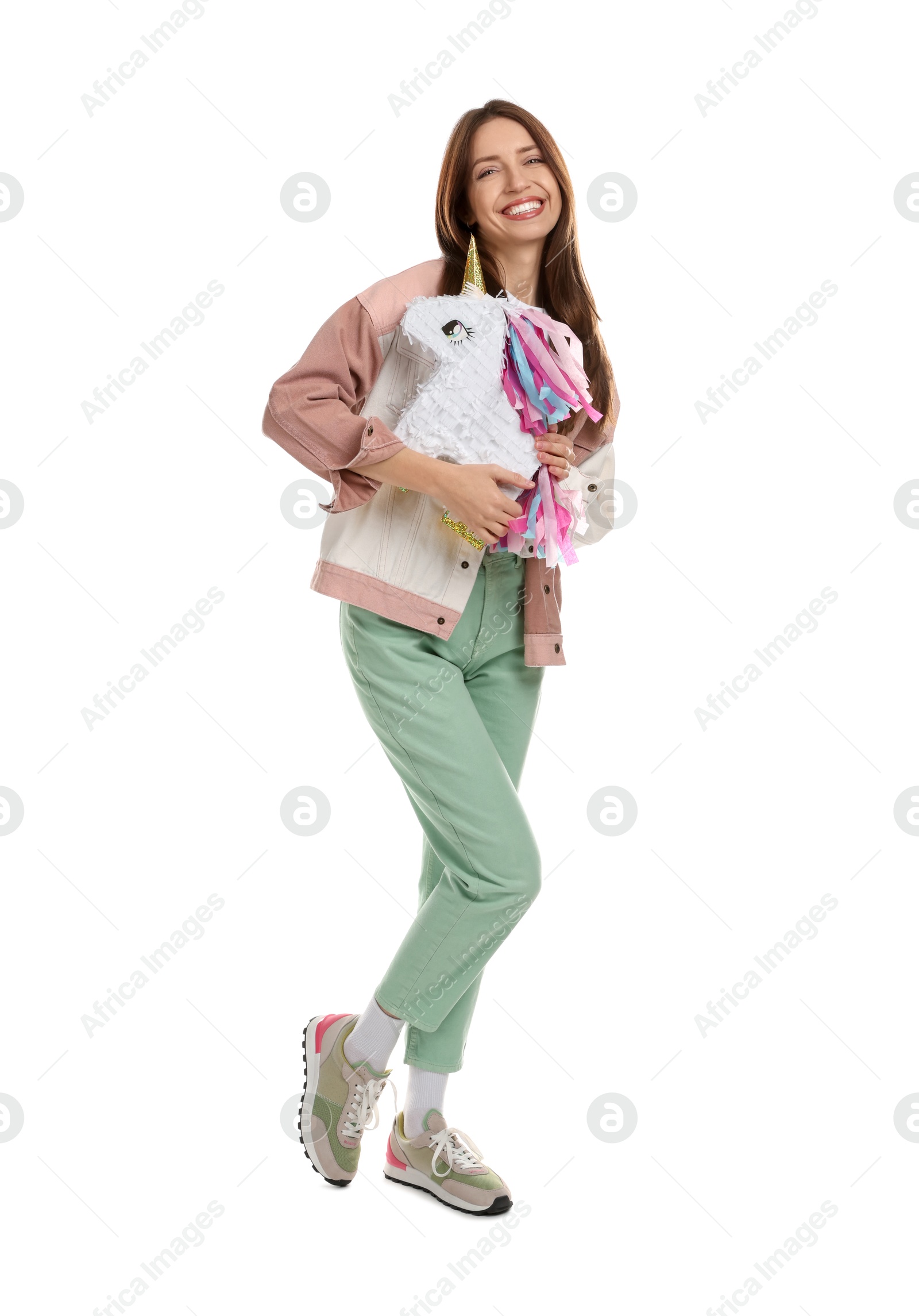 Photo of Happy woman with unicorn shaped pinata isolated on white