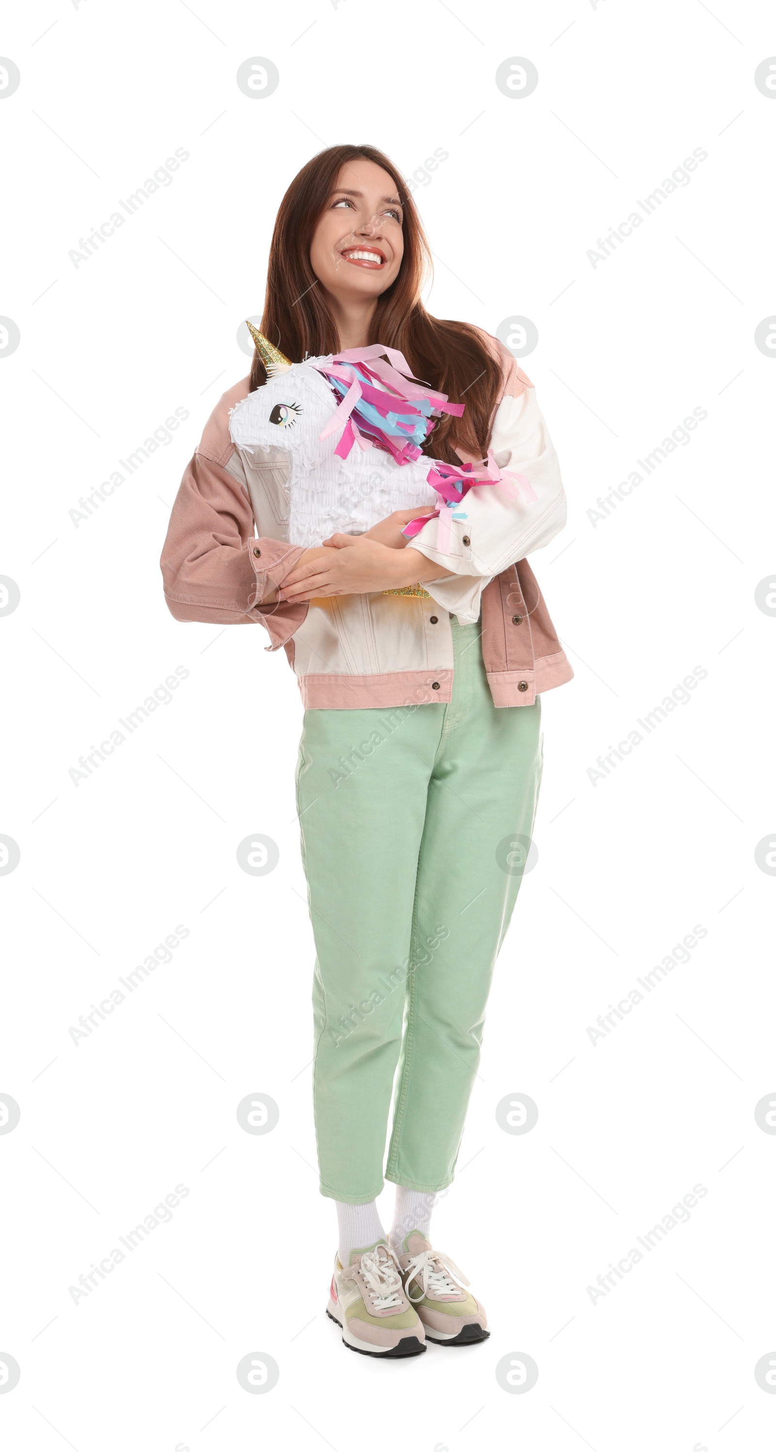 Photo of Happy woman with unicorn shaped pinata isolated on white