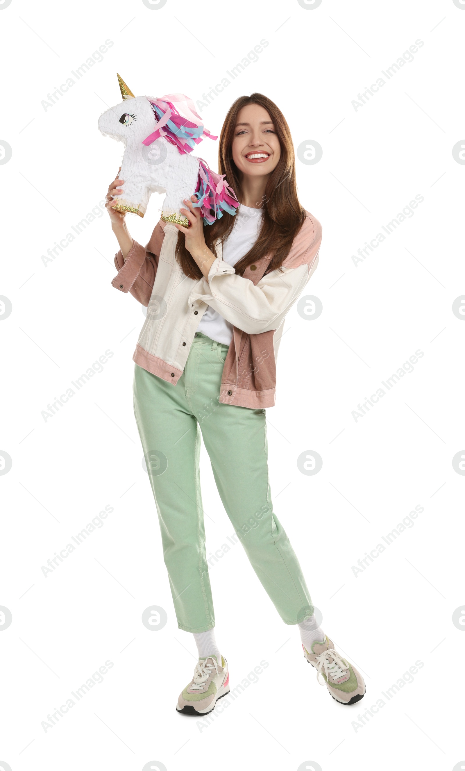 Photo of Happy woman with unicorn shaped pinata isolated on white