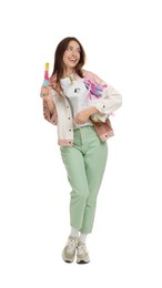 Photo of Happy woman with unicorn shaped pinata and stick isolated on white