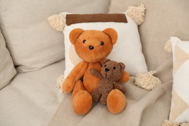 Photo of Cute stuffed bears on sofa at home