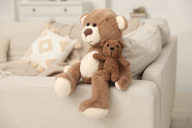 Photo of Cute stuffed bears on sofa at home