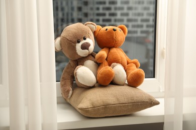 Photo of Teddy bears on window sill at home